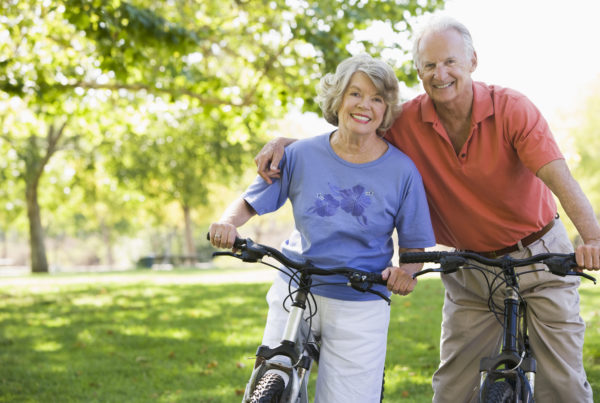 Elderly Couple Cycling in Countryside