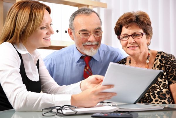 Senior couple meeting with financial advisor about Medicare supplement rate increase